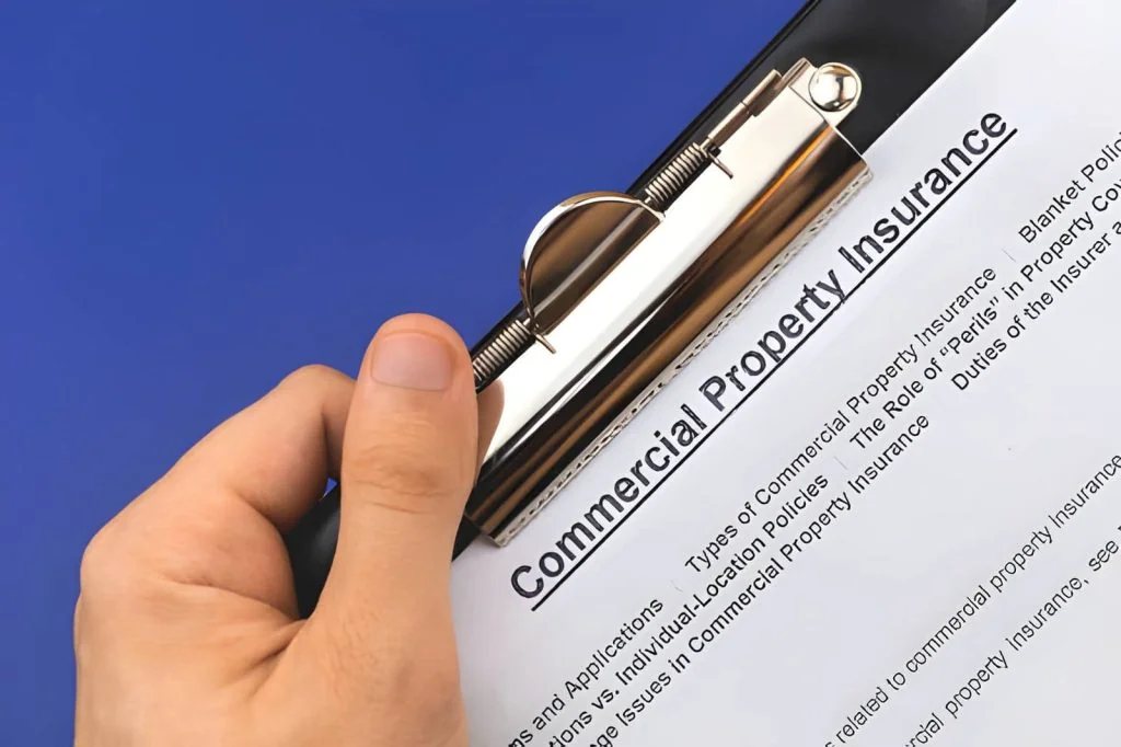 Palm Beach Gardens commercial claims public adjuster reviewing commercial property insurance document on clipboard
